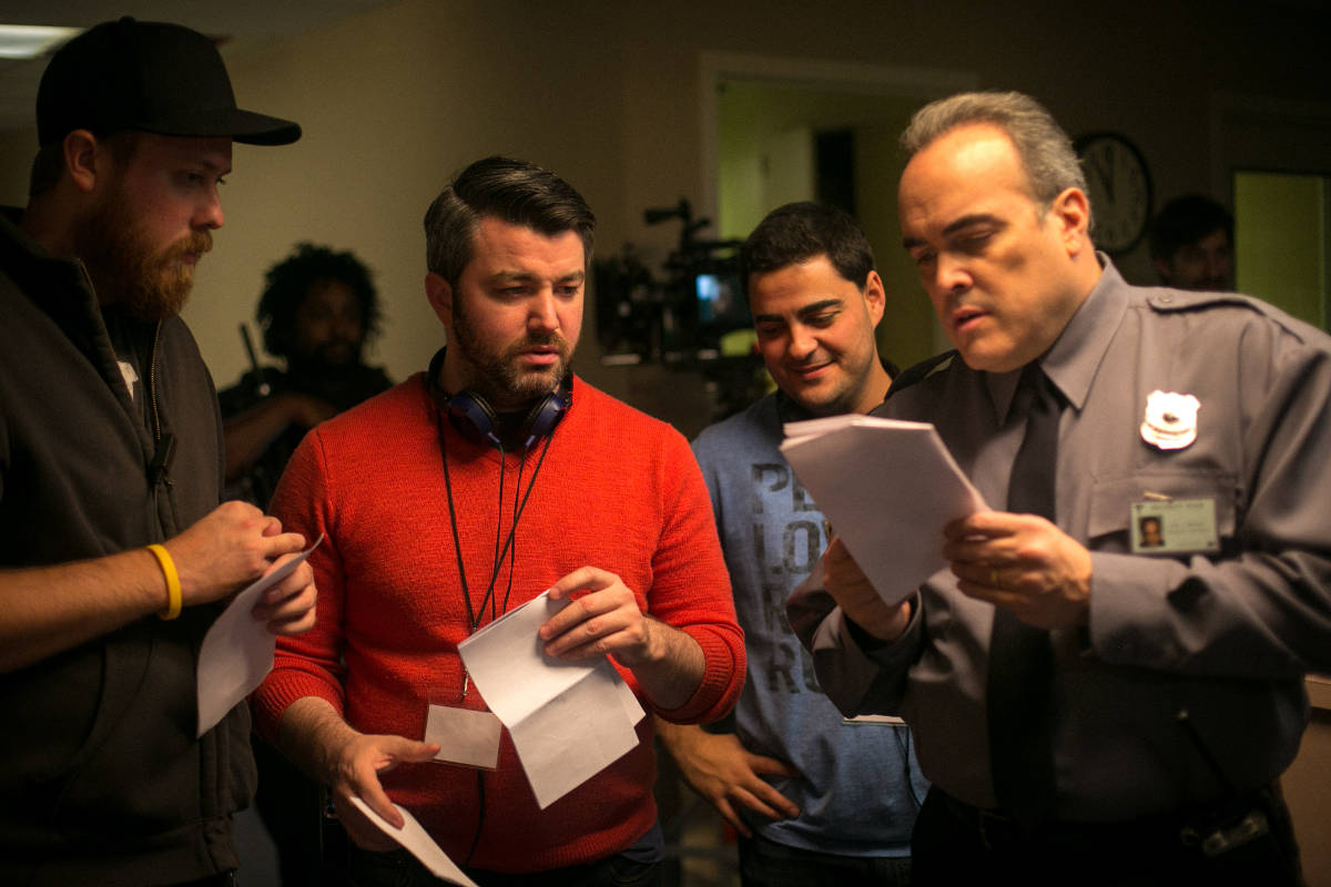 1st AD Blake Brewer, Director Jeremy Profe, and Producer Gabriel Francisco review an upcoming scene with David Zayas.