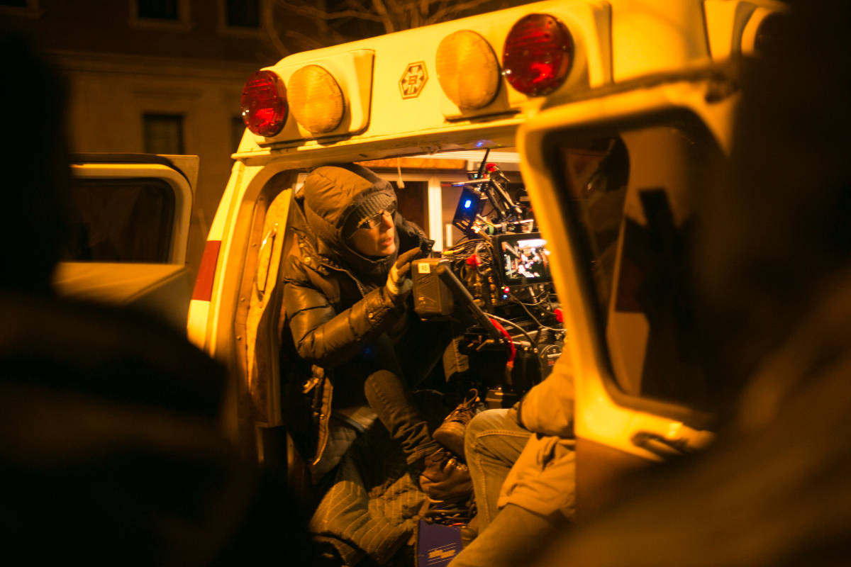 Working against the bitter cold and the cramped confines of a vintage ambulance Director of Photography Lisa Rinzler sets up her shot.