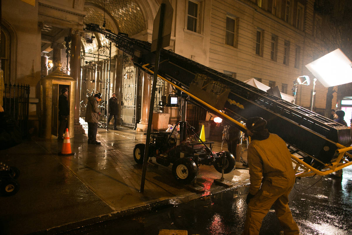A booming shot that soars over the wrought iron gates of the "Dakota" set is tested on the technocrane.